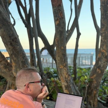 Serge Bulaev at a laptop by the ocean